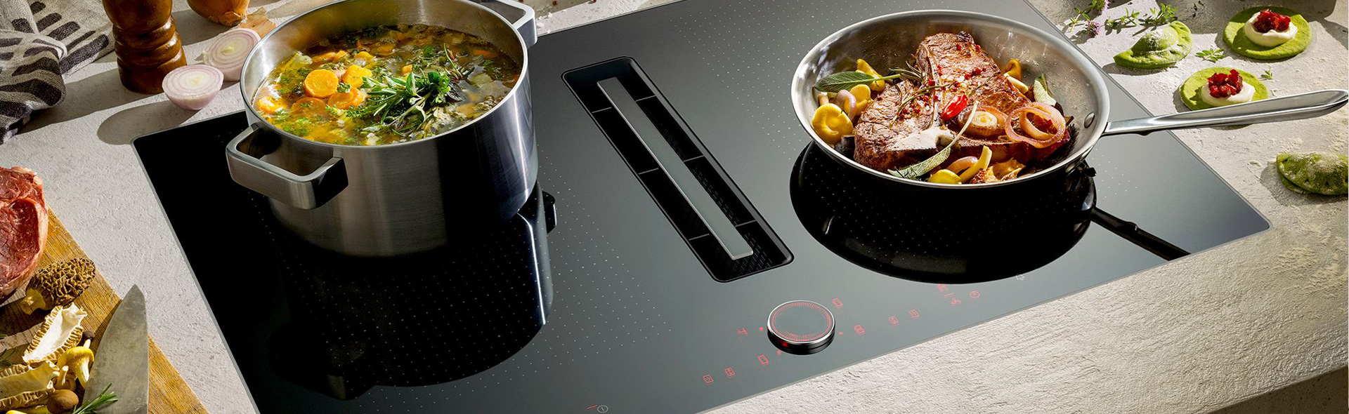 gefüllte Pfanne und Topf auf einem Induktionskochfeld